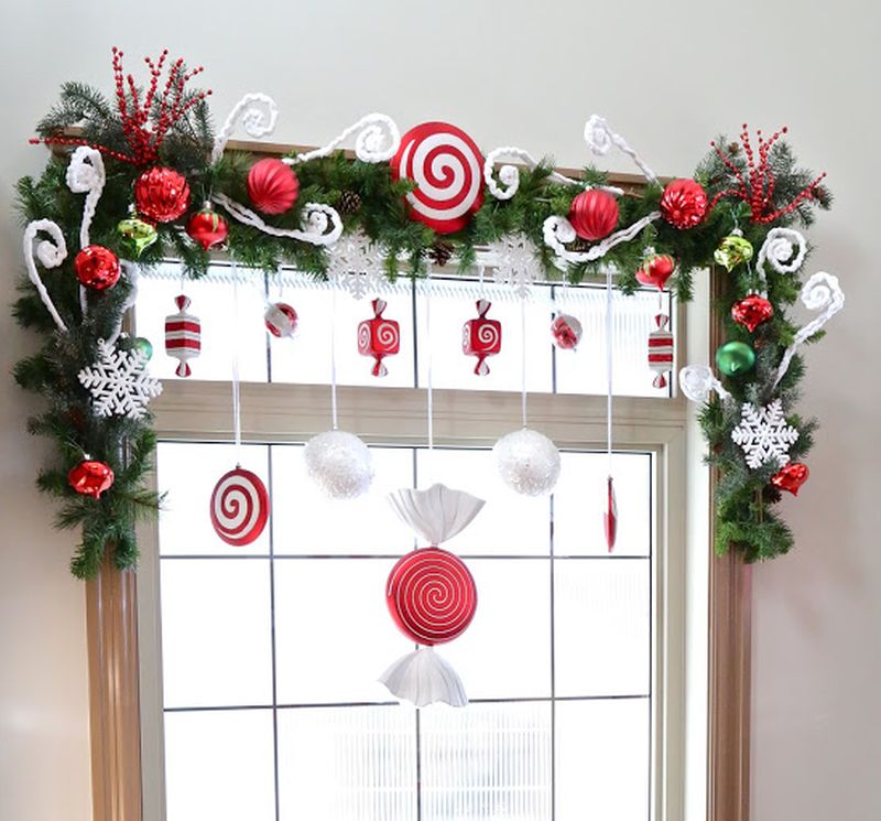 greenery and christmas ornaments on window  