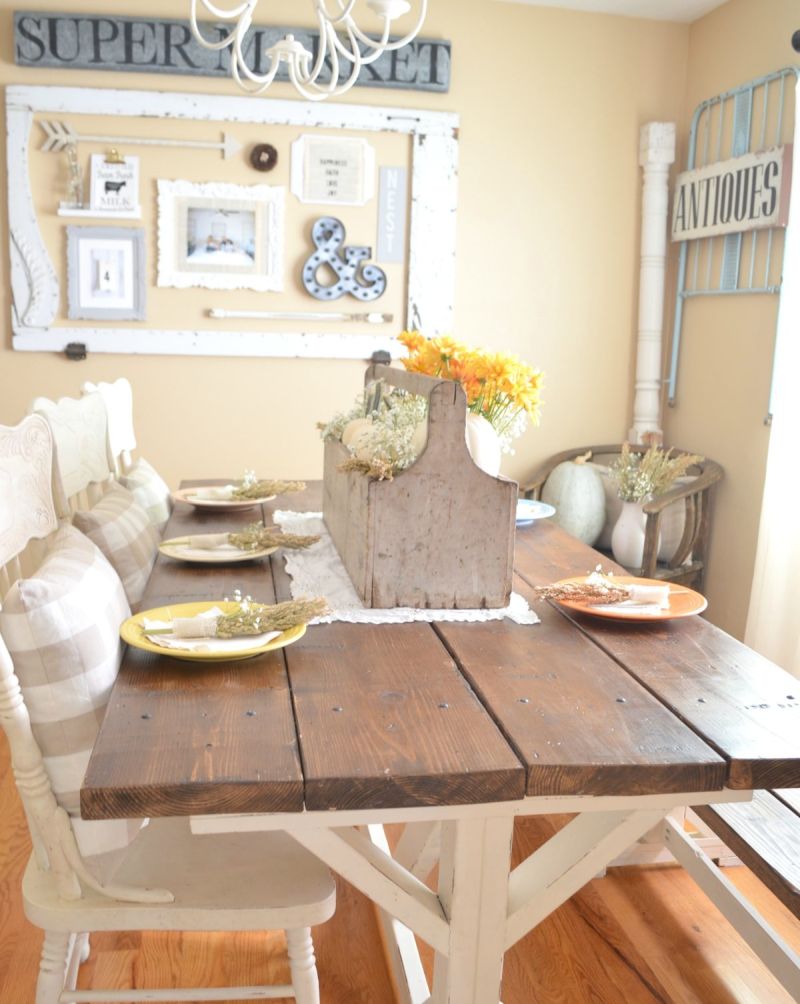 Vintage Thanksgiving table setting with wooden toolbox centerpiece filled with mini pumpkins and flowers