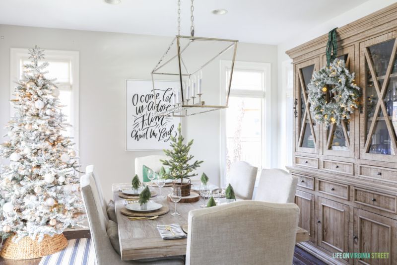 Woodland Christmas dining table decor with a mix of stripes, metallics, neutrals and pine trees