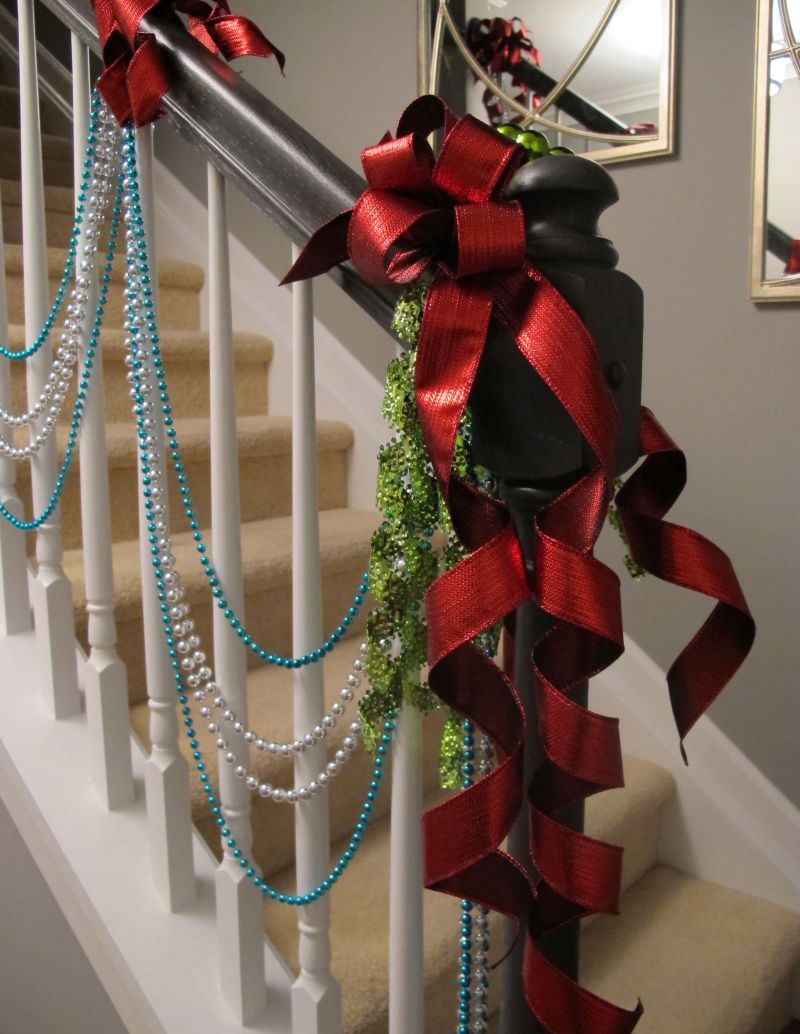 Christmas Staircase Decoration with red ribbon, pearl garland and shrubs 