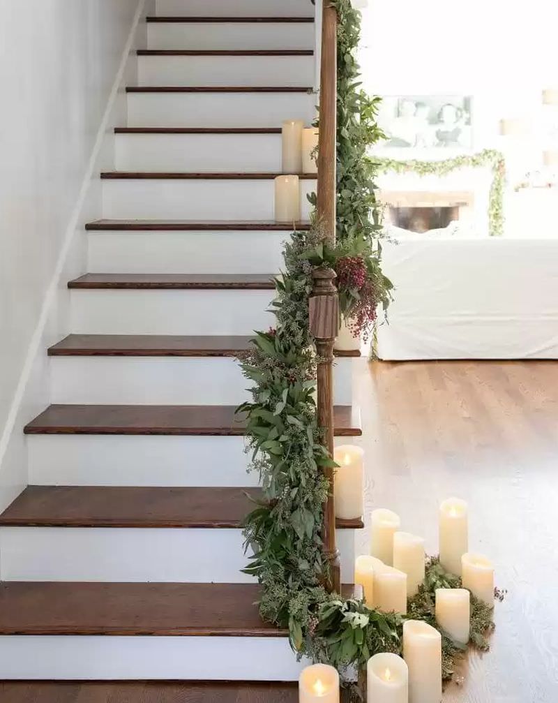 stairs draped in garland filled with pepper berries, bay leaves and eucalyptus 
