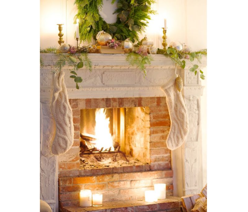 Christmas Fireplace Mantel Decoration with glittery ornaments and greenery  
