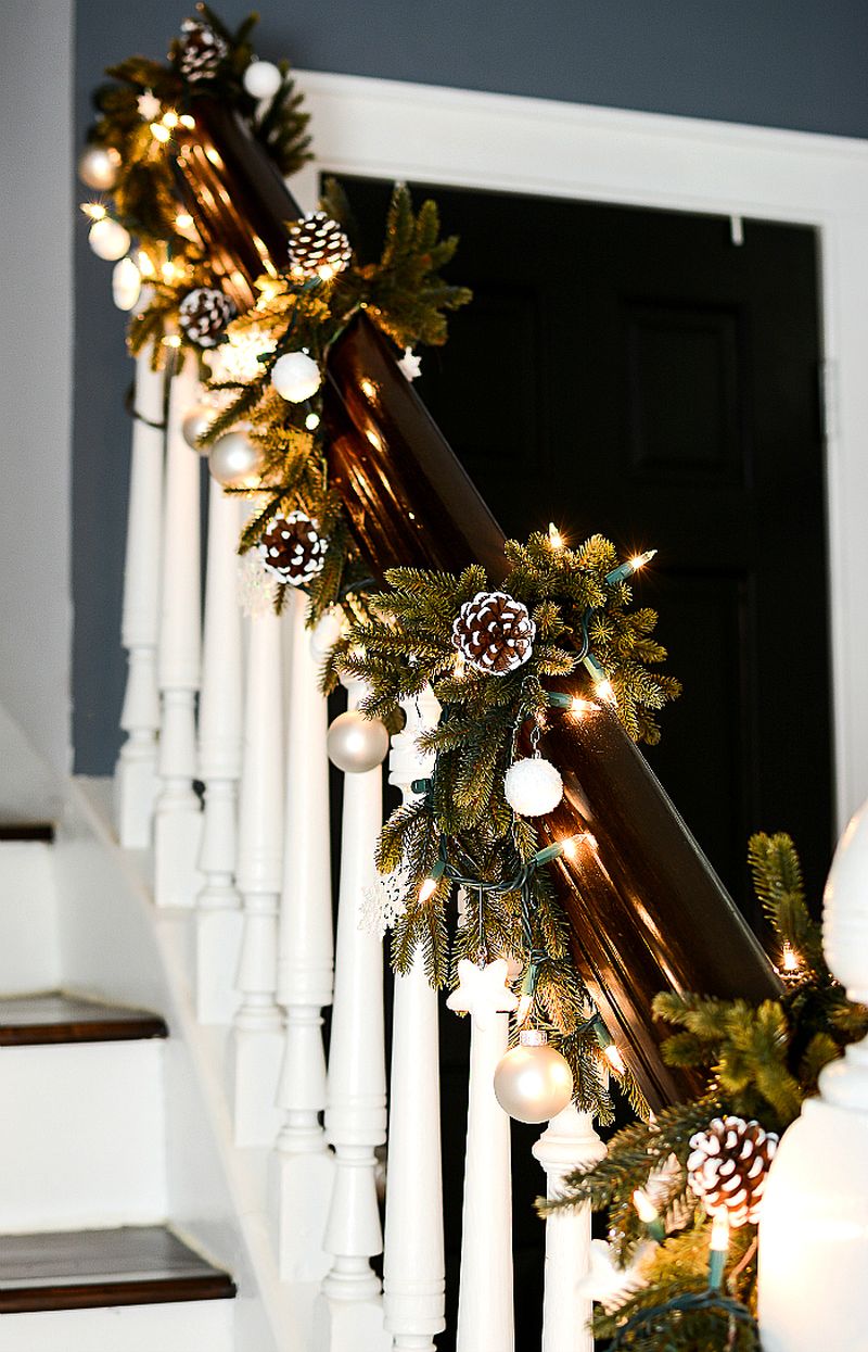 Painted pine cones with green garland on staircase 