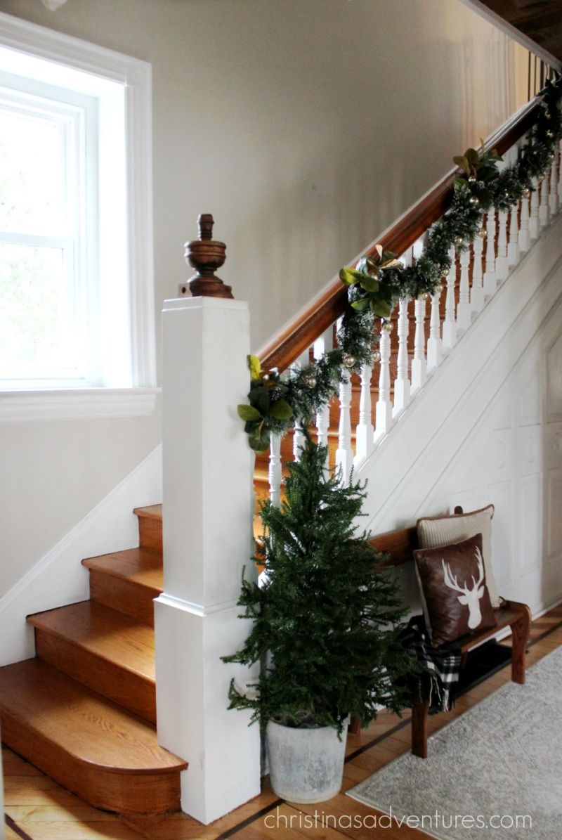 Staircase decoration with hanging garland and magnolia leaves 