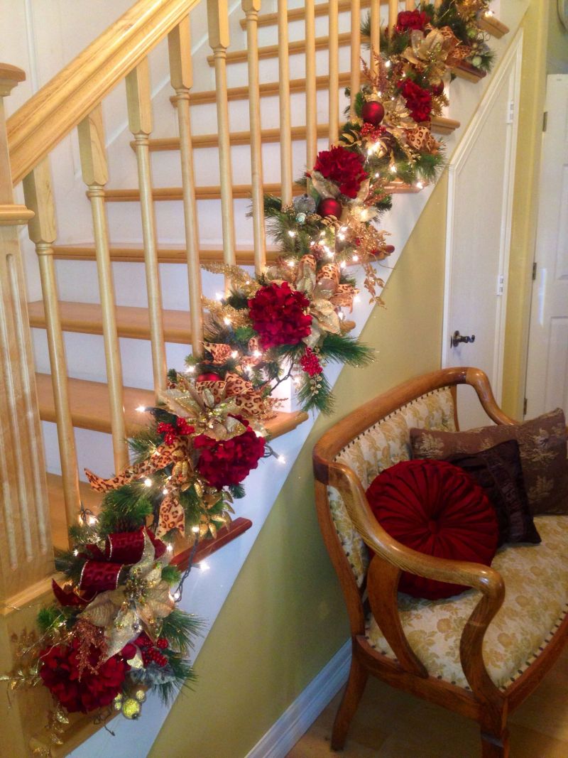 Ribbon, ornaments, flower and greenery lying on staircase edge 