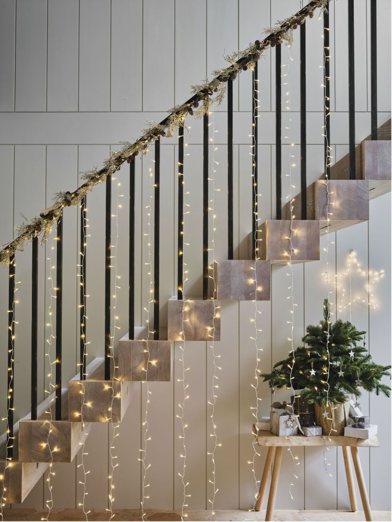Light strips hanging from staircase railing 