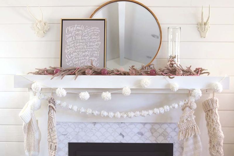 Christmas garland from pom poms over fireplace mantel